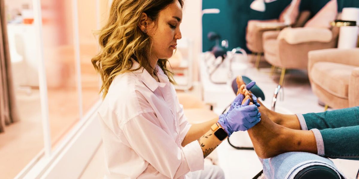 A professional helping moisturise feet